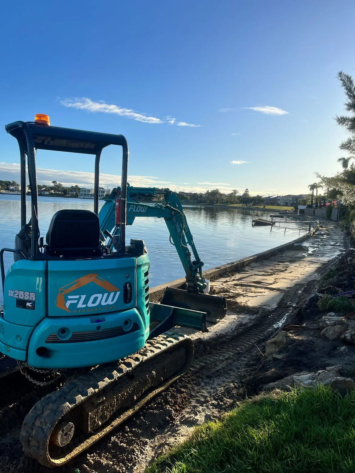 Flow excavator working beside the waterfront